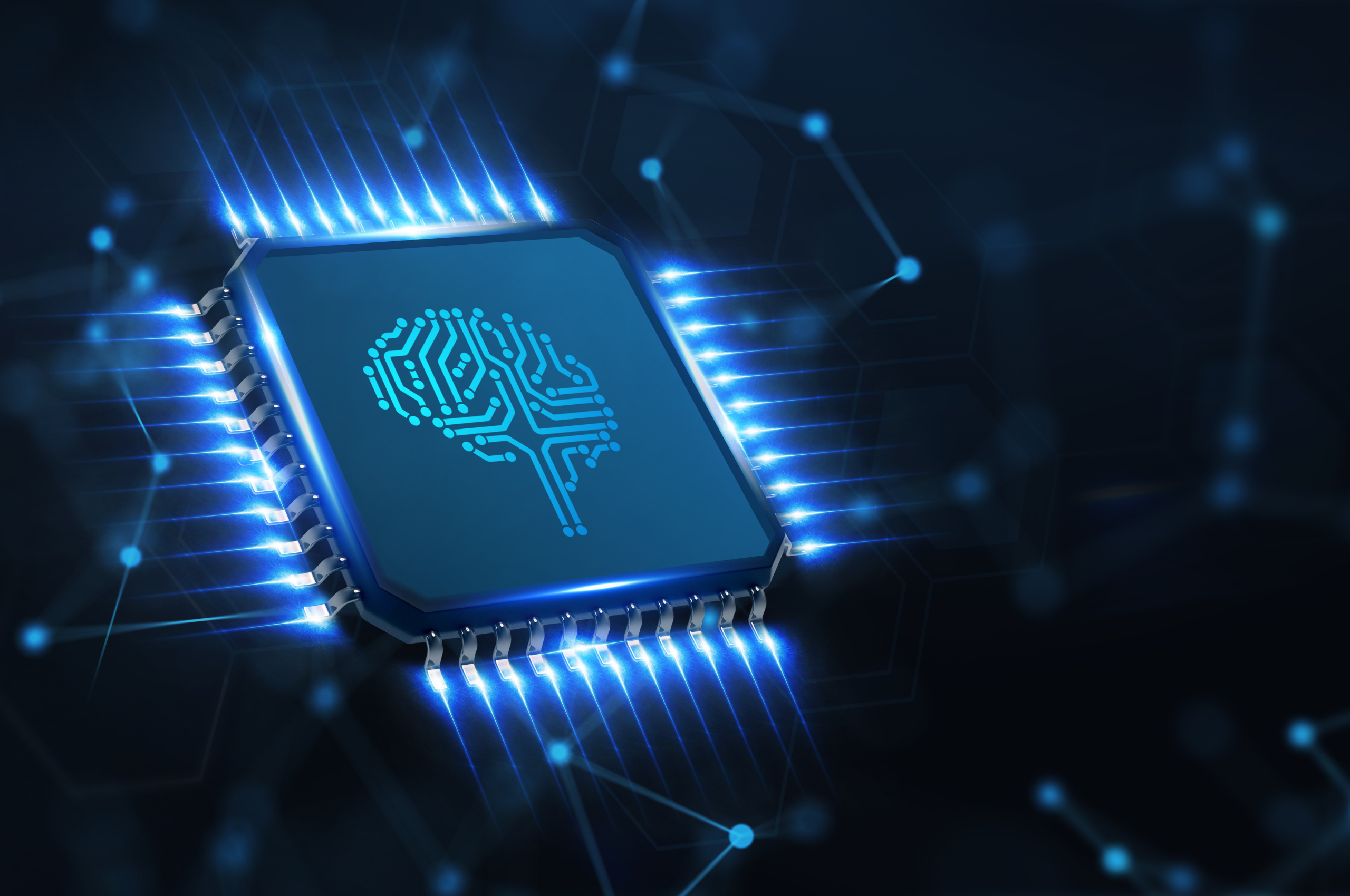Digital technology chip with a brain. icon on the front screen. Illuminated blue lines coming off the digital chip at all angles that fade into the dark background. Dark background with faded blue line and dot connections. The Impact of Artificial Intelligence on MedTech Recruitment.